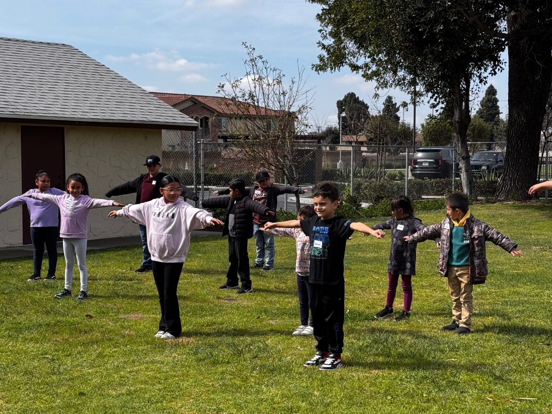 Children spaced out on the grass playing games at a church outreach