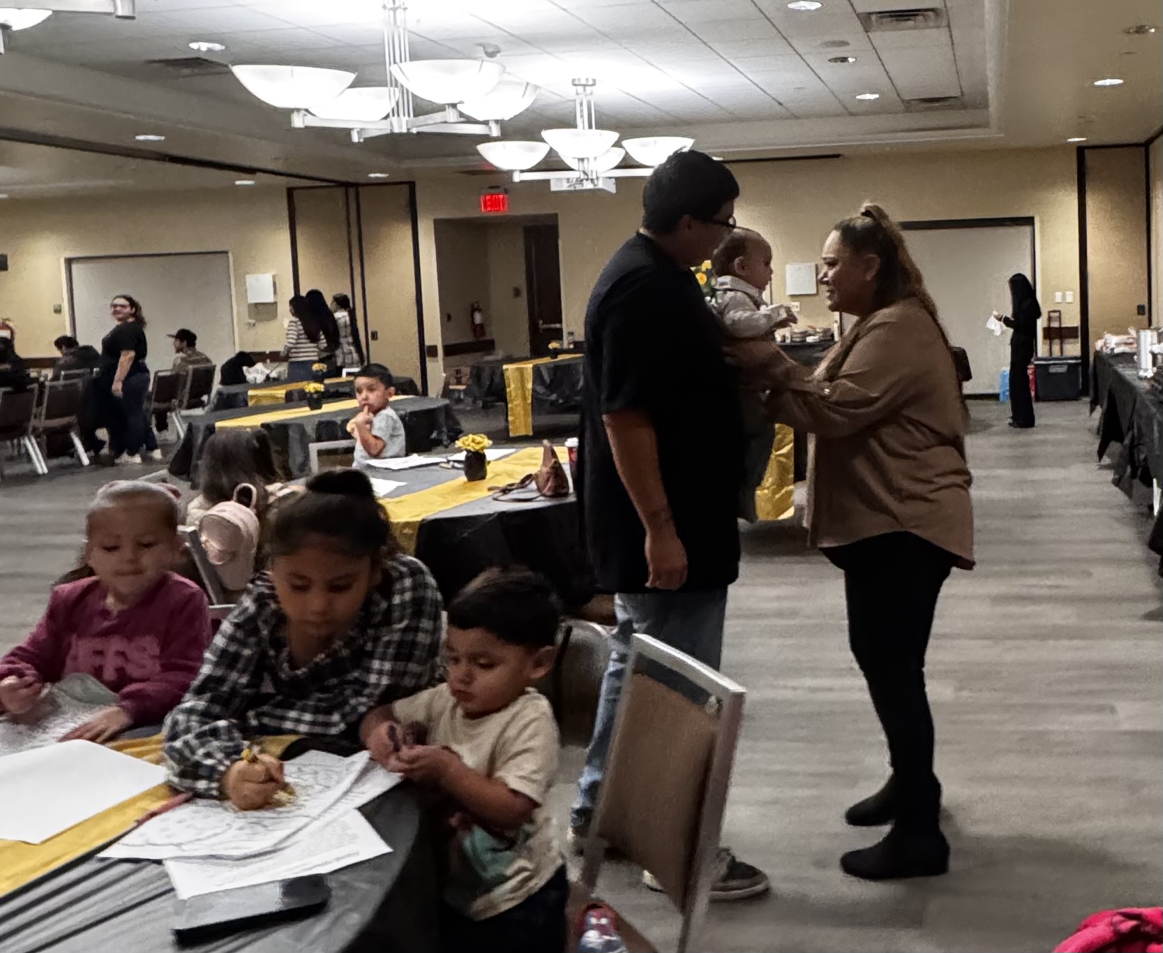 Families gathered around tables at a church fellowship dinner
