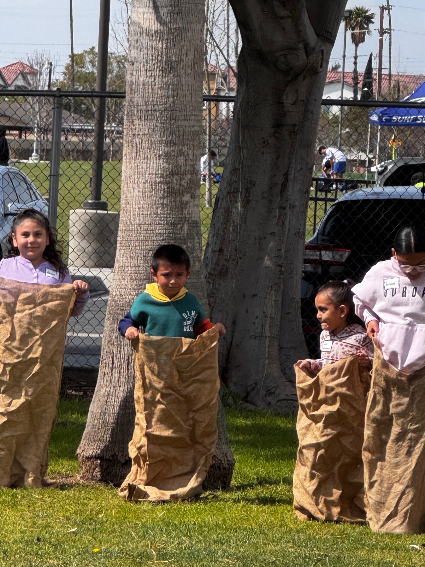 Children lining up for a sack race during a family fun day